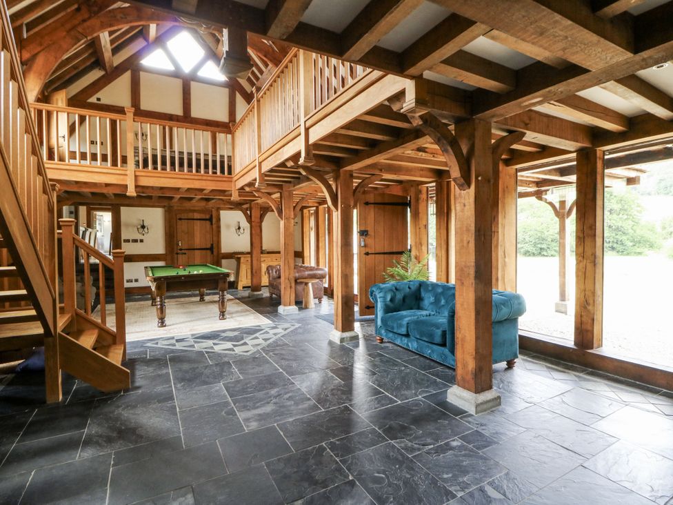 A living room with a snooker table and staircase at Stud Farm House Bleddfa near Knighton