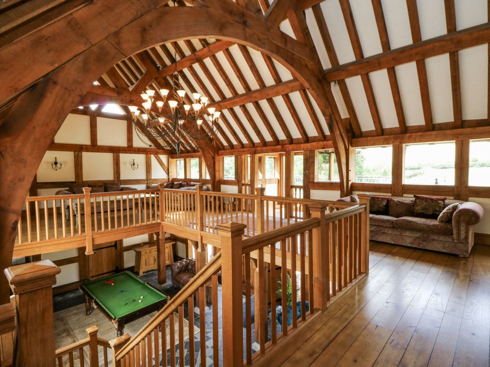 A living room with a balcony and a pool table at Stud Farm House in Bleddfa near Knighton