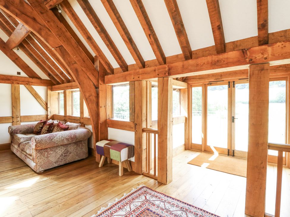 A living room with a sofa and rug at Stud Farm House Bleddfa near Knighton