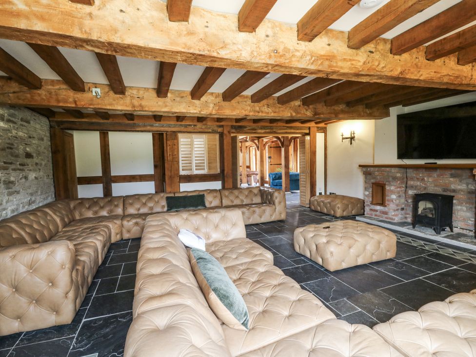 A living room with a large sofa and footstools at Stud Farm House Bleddfa near Knighton