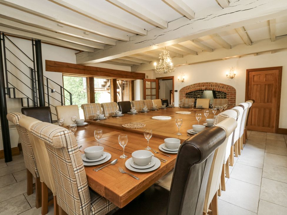A dining room with a large table set for meals at Stud Farm House Bleddfa near Knighton