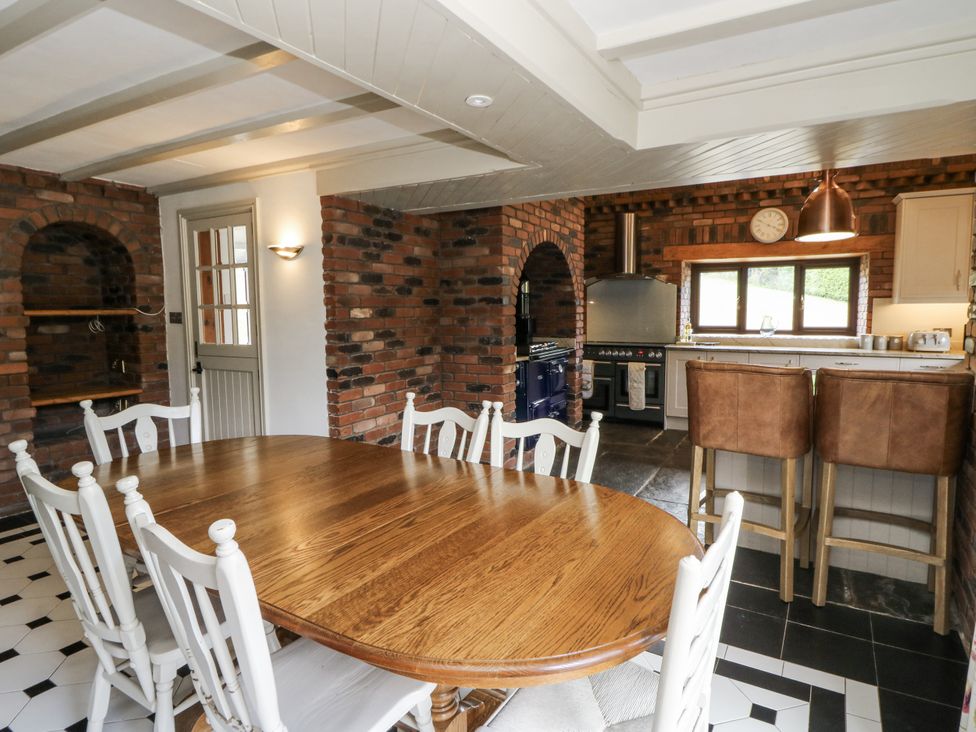 A dining room with a table and chairs at Stud Farm House in Bleddfa near Knighton