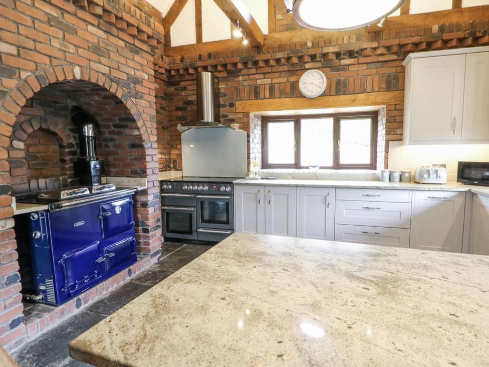 A kitchen with a blue oven and stone countertop at Stud Farm House Bleddfa near Knighton