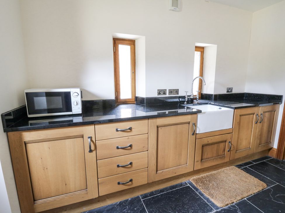 A kitchen with a sink and microwave at Stud Farm House Bleddfa near Knighton