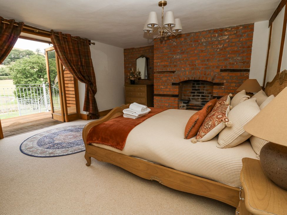A bedroom with a bed and a view of the outdoors at Stud Farm House Bleddfa near Knighton