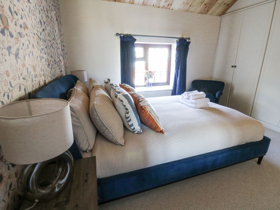 A bedroom with a bed and window at Stud Farm House Bleddfa near Knighton
