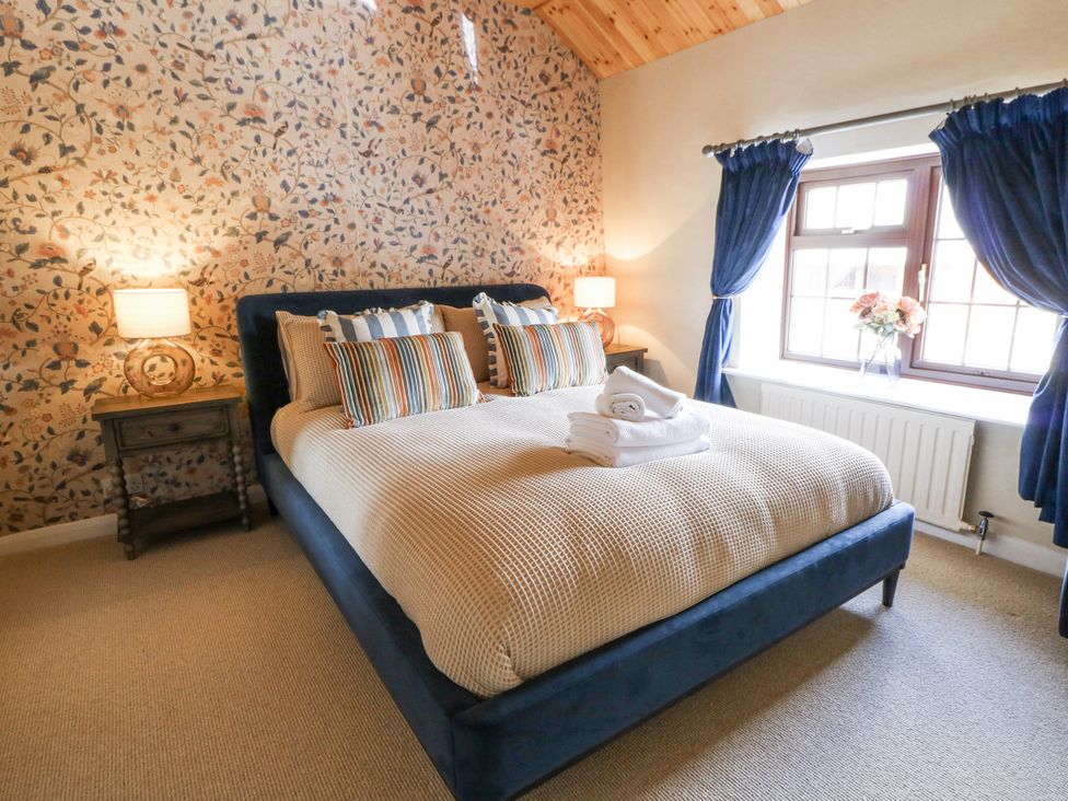 A bedroom with a bed and side table at Stud Farm House in Bleddfa near Knighton