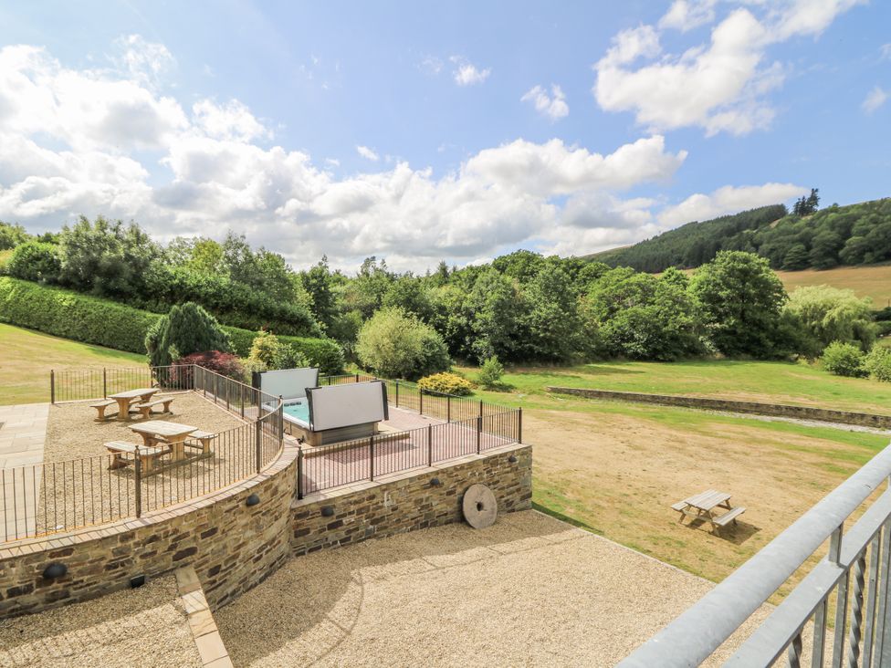 An outdoor area with seating and greenery at Stud Farm House in Bleddfa near Knighton