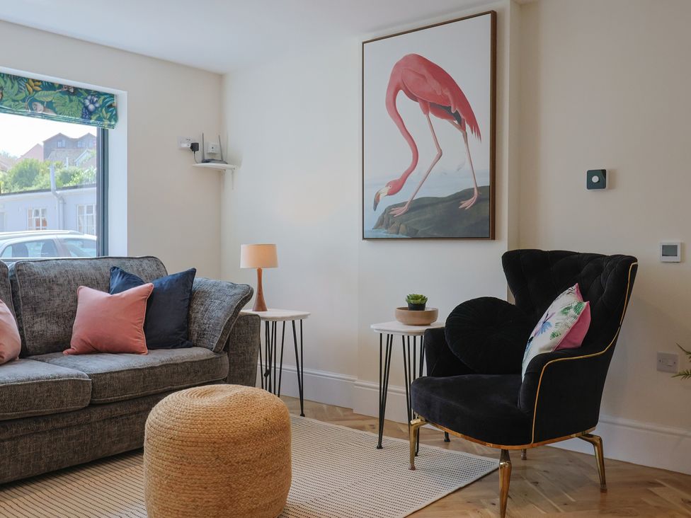 A living room with a sofa and side table at 1 Mill Green Court Lyme Regis