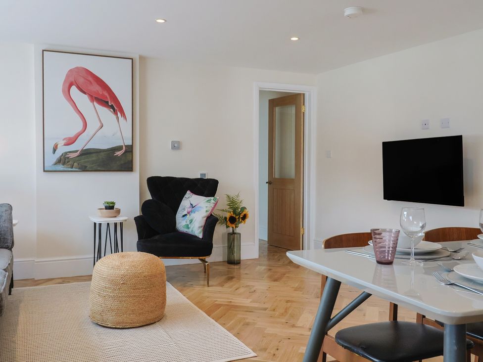 A living room with a television and artwork at 1 Mill Green Court in Lyme Regis