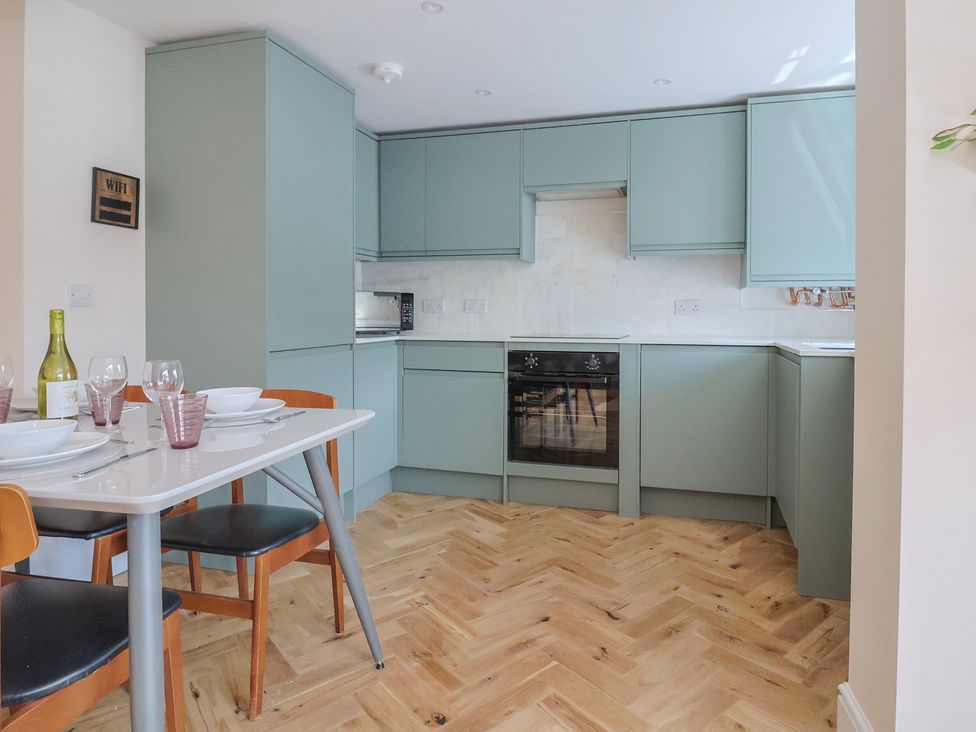 A kitchen with a dining table and chairs at 1 Mill Green Court Lyme Regis