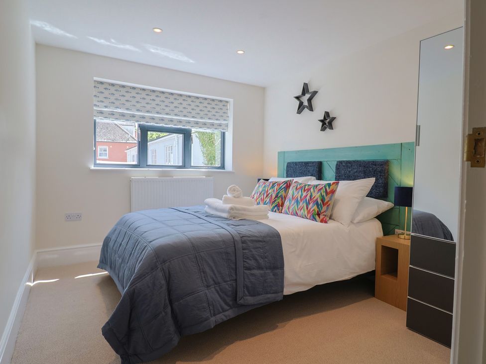 A bedroom with a bed and bedside table at 1 Mill Green Court Lyme Regis