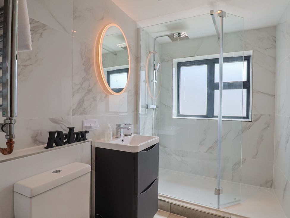 A bathroom with a shower and sink at 1 Mill Green Court in Lyme Regis