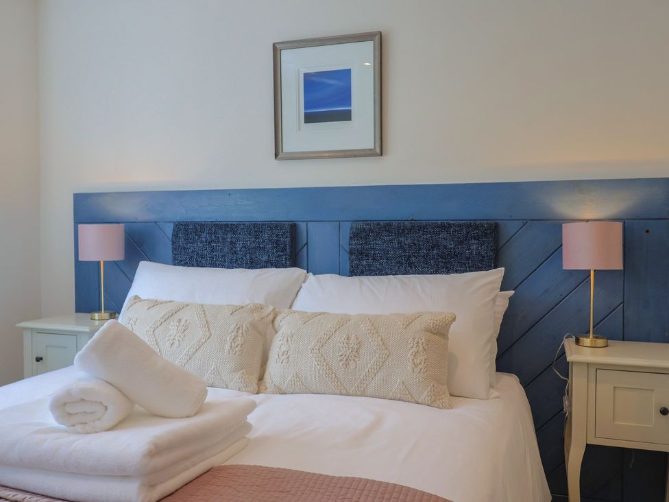 A bedroom with a bed and bedside lamps at 1 Mill Green Court in Lyme Regis