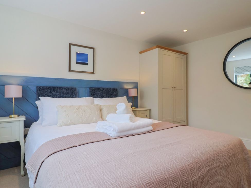 A bedroom with a bed and furniture at 1 Mill Green Court in Lyme Regis