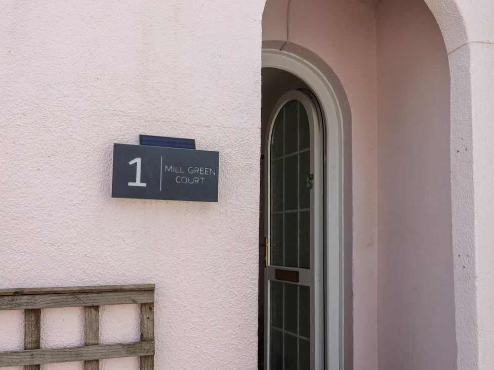 An entrance with a door and nameplate at 1 Mill Green Court in Lyme Regis