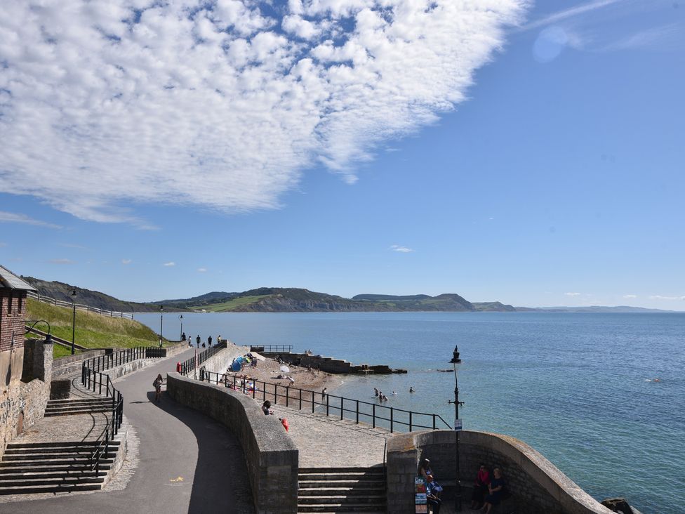A coastal view with a beach and path at 1 Mill Green Court in Lyme Regis