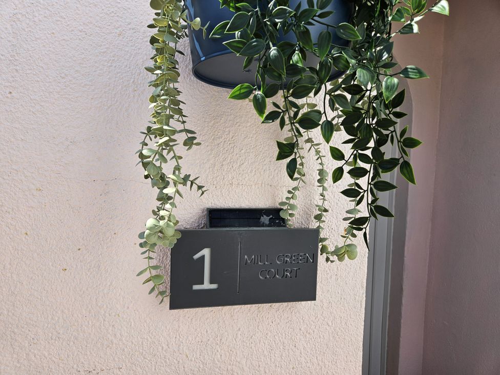 A sign with the number 1 and the name Mill Green Court at 1 Mill Green Court Lyme Regis