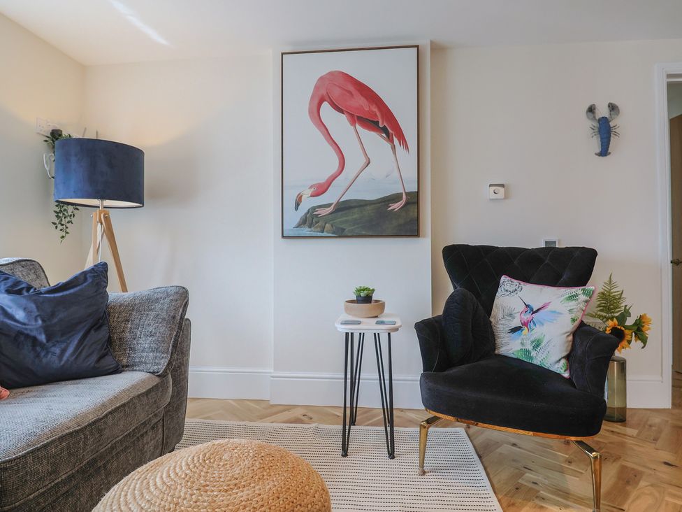 A living room with a sofa and armchair at 1 Mill Green Court Lyme Regis