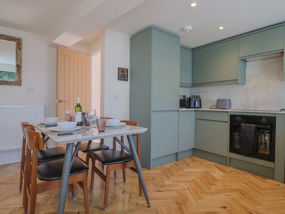 A kitchen with a dining table and chairs at 1 Mill Green Court Lyme Regis