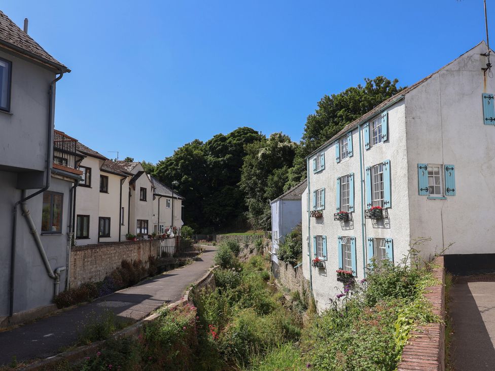 Houses along a pathway with greenery at 1 Mill Green Court, Lyme Regis