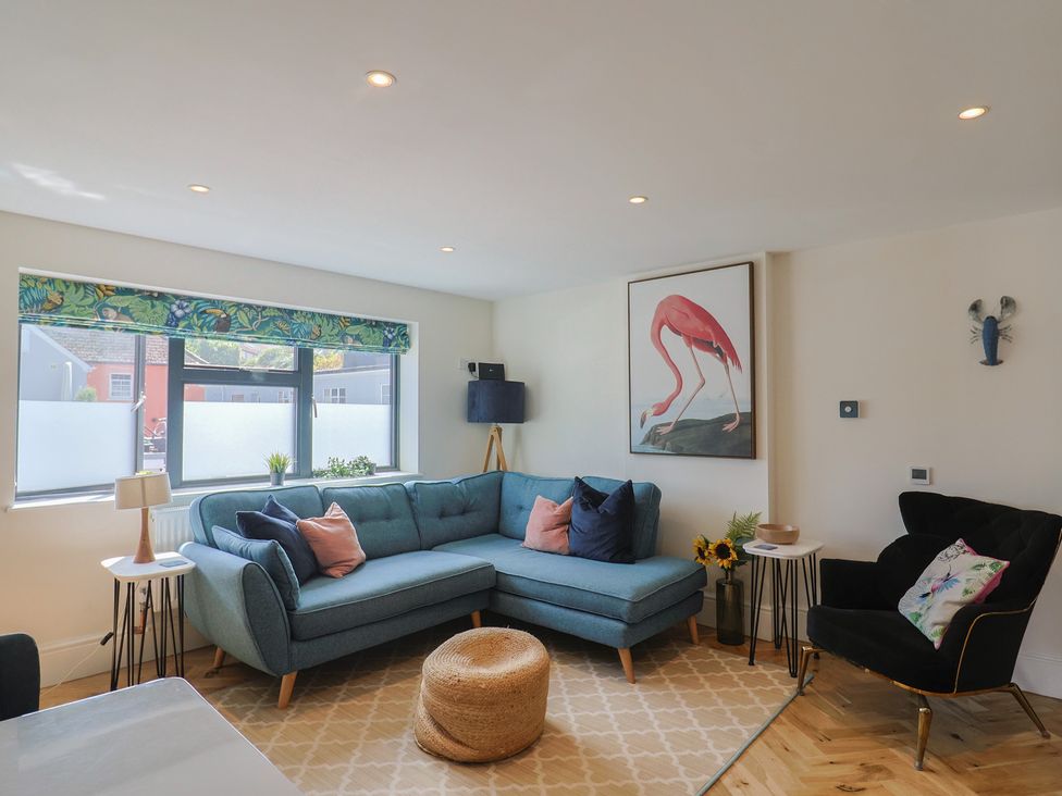 A living room with a sofa and artwork at 1 Mill Green Court Lyme Regis