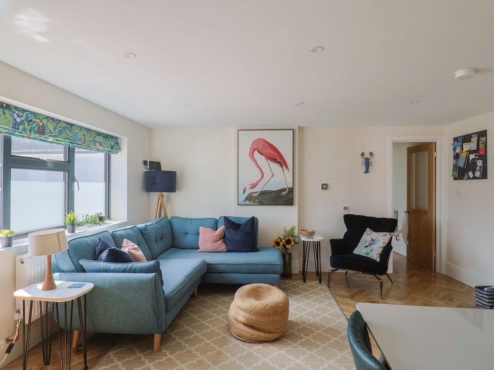 A living room with a sofa and coffee table at 1 Mill Green Court in Lyme Regis