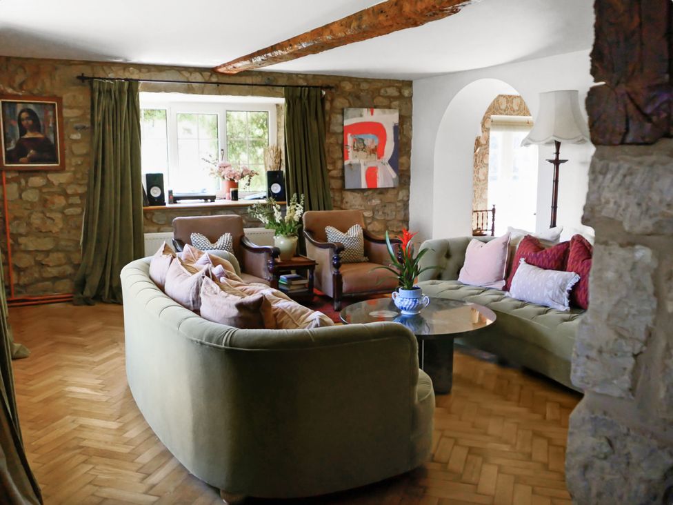 A living room with a sofa and coffee table at Tuckers Farm in Gatcombe