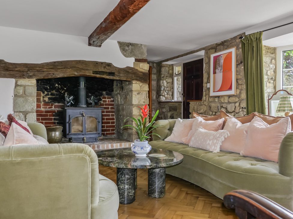 A living room with a sofa and coffee table at Tuckers Farm in Gatcombe