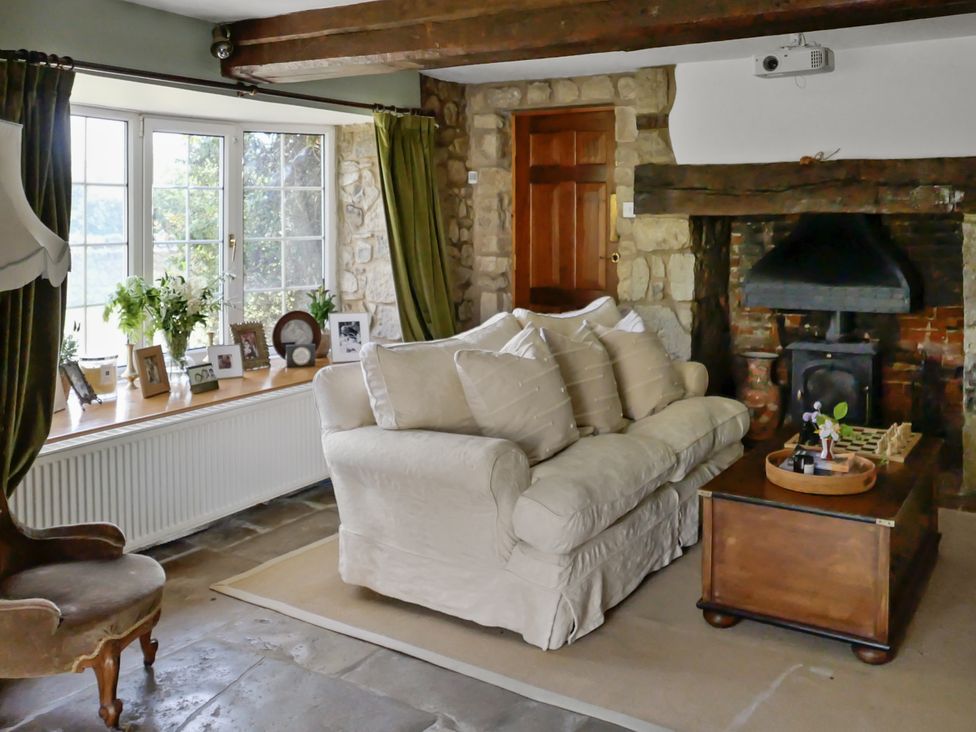 A living room with a sofa and coffee table at Tuckers Farm in Gatcombe