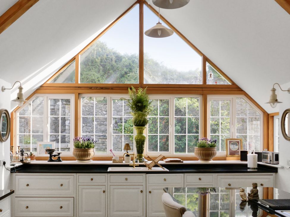 A kitchen with a window and counter at Tuckers Farm in Gatcombe