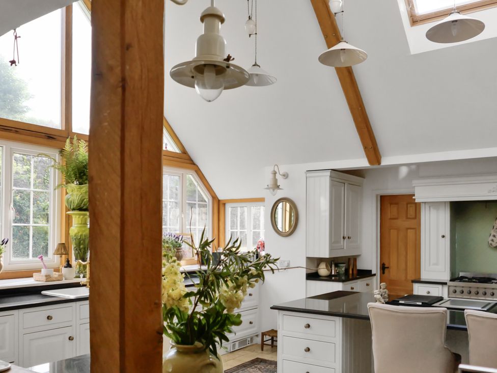 A kitchen with cabinets, countertop, and a sink at Tuckers Farm in Gatcombe