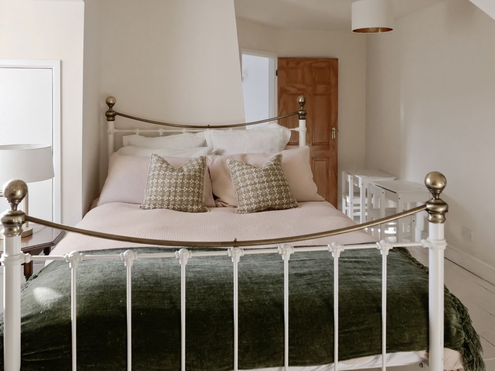 A bedroom with a bed and side tables at Tuckers Farm in Gatcombe