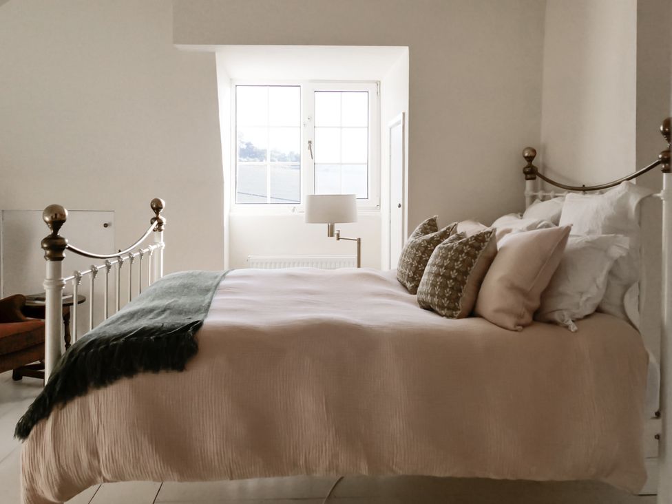 A bedroom with a bed and lamp at Tuckers Farm in Gatcombe