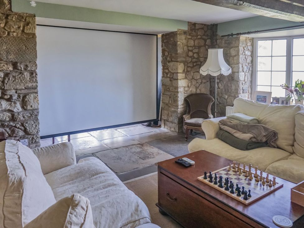 A living room with a chess set on a table at Tuckers Farm in Gatcombe