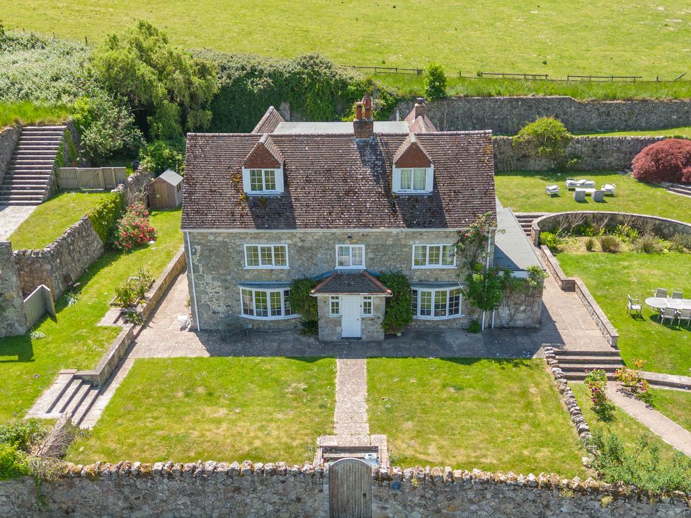 An aerial view of a house with garden and seating area at Tuckers Farm in Gatcombe