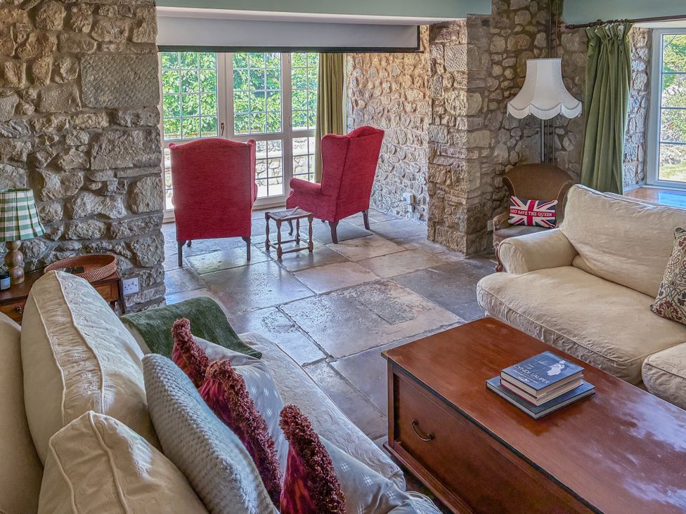 A living room with a sofa and armchairs at Tuckers Farm in Gatcombe
