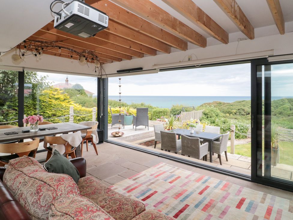 A living room with a view of the garden at Sea Haven in Hunmanby Gap near Primrose Valley
