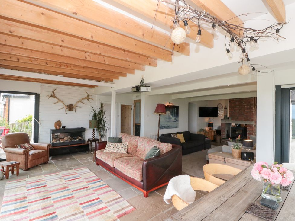 A living room with a sofa and armchair in Sea Haven near Hunmanby Gap