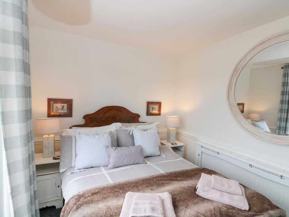 A bedroom with a bed and bedside tables at Sea Haven near Hunmanby Gap