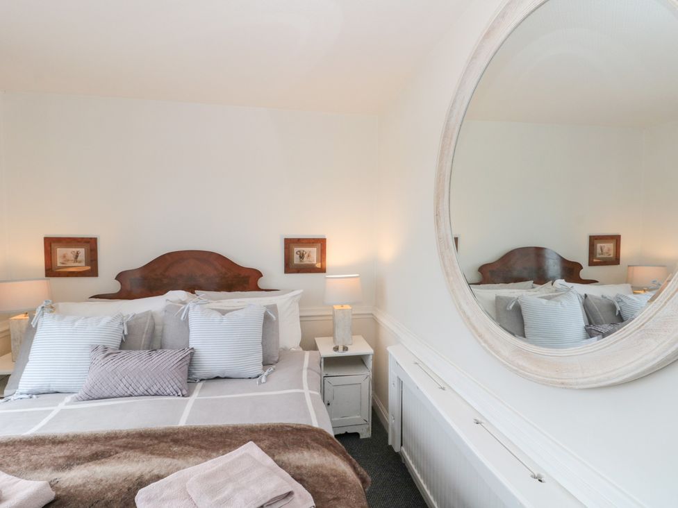 A bedroom with a bed and decorations at Sea Haven near Hunmanby Gap