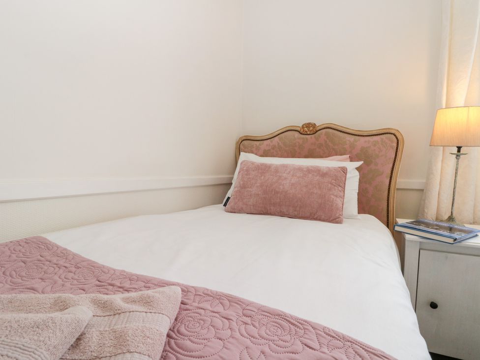 A bed with pillows and a lamp at Sea Haven in Hunmanby Gap near Primrose Valley