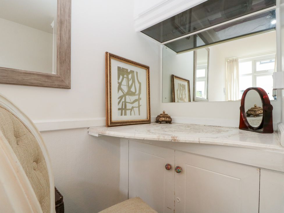 A dressing area with a vanity and mirror at Sea Haven, Hunmanby Gap near Primrose Valley