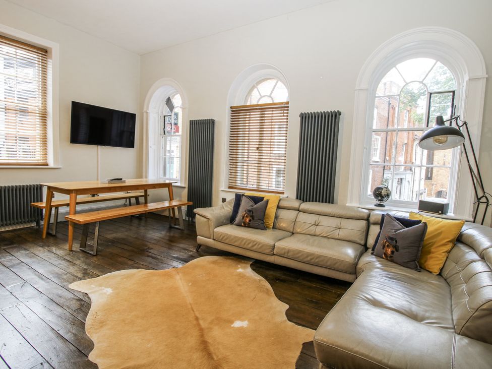 A living room with a sofa and dining table at 1C College Hill Shrewsbury