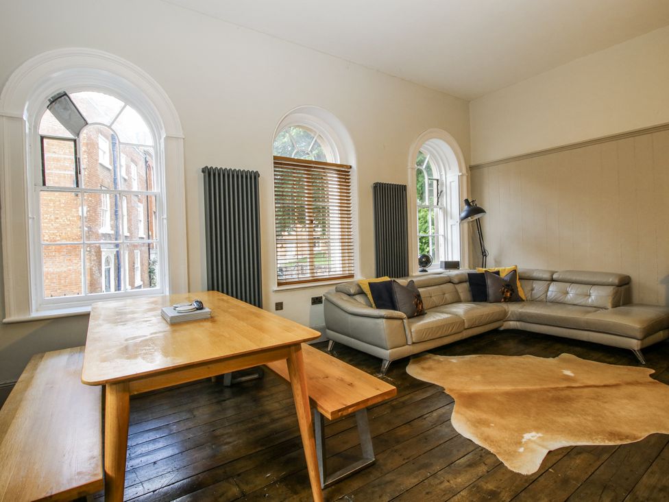 A living room with a table and sofa at 1C College Hill in Shrewsbury