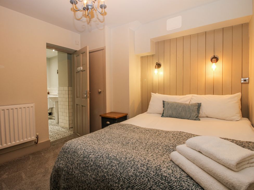 A bedroom with a bed and nightstand at 1C College Hill Shrewsbury