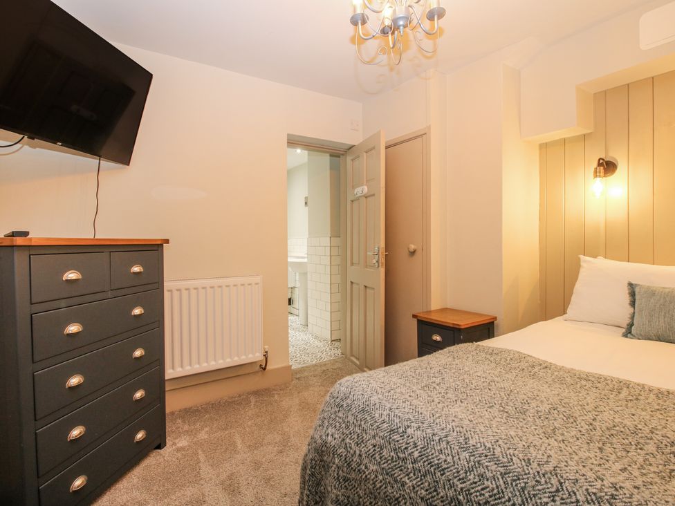 A bedroom with a bed and television at 1C College Hill in Shrewsbury