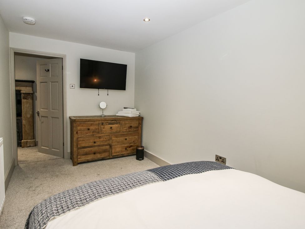 A bedroom with a dresser and television at 1C College Hill in Shrewsbury