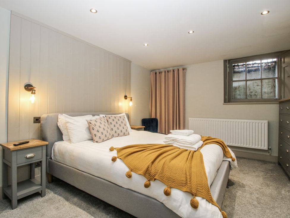 A bedroom with a bed and bedside table at 1C College Hill in Shrewsbury