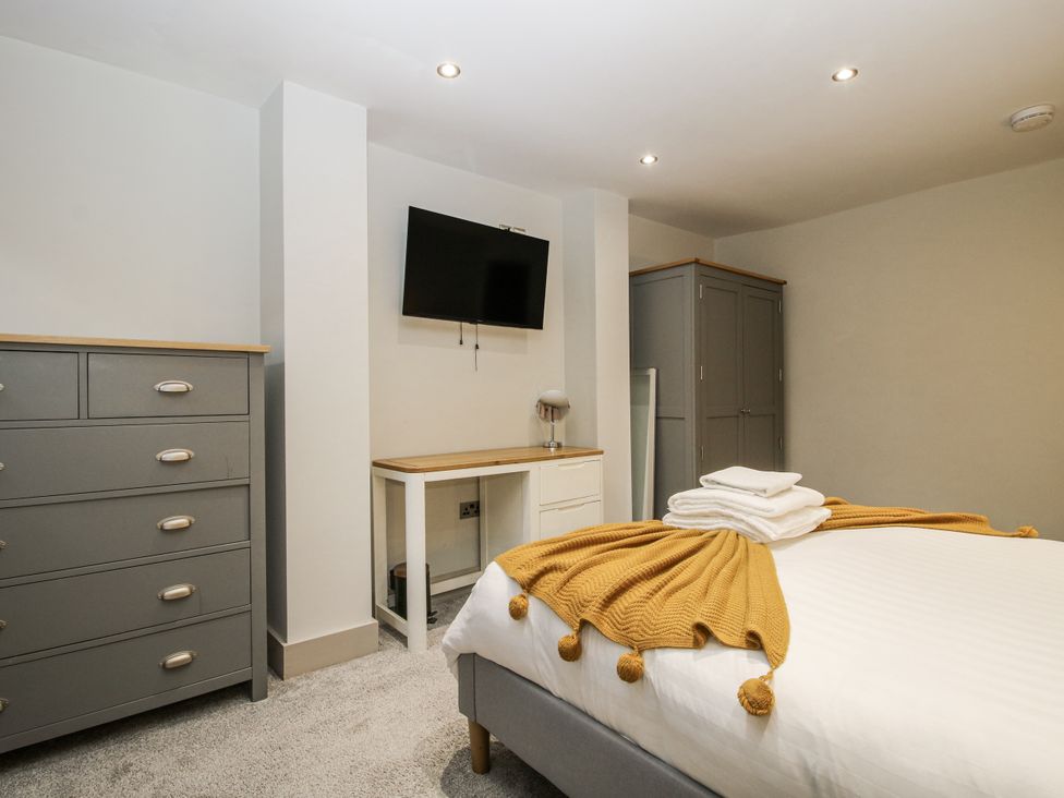 A bedroom with a bed and furniture at 1C College Hill Shrewsbury